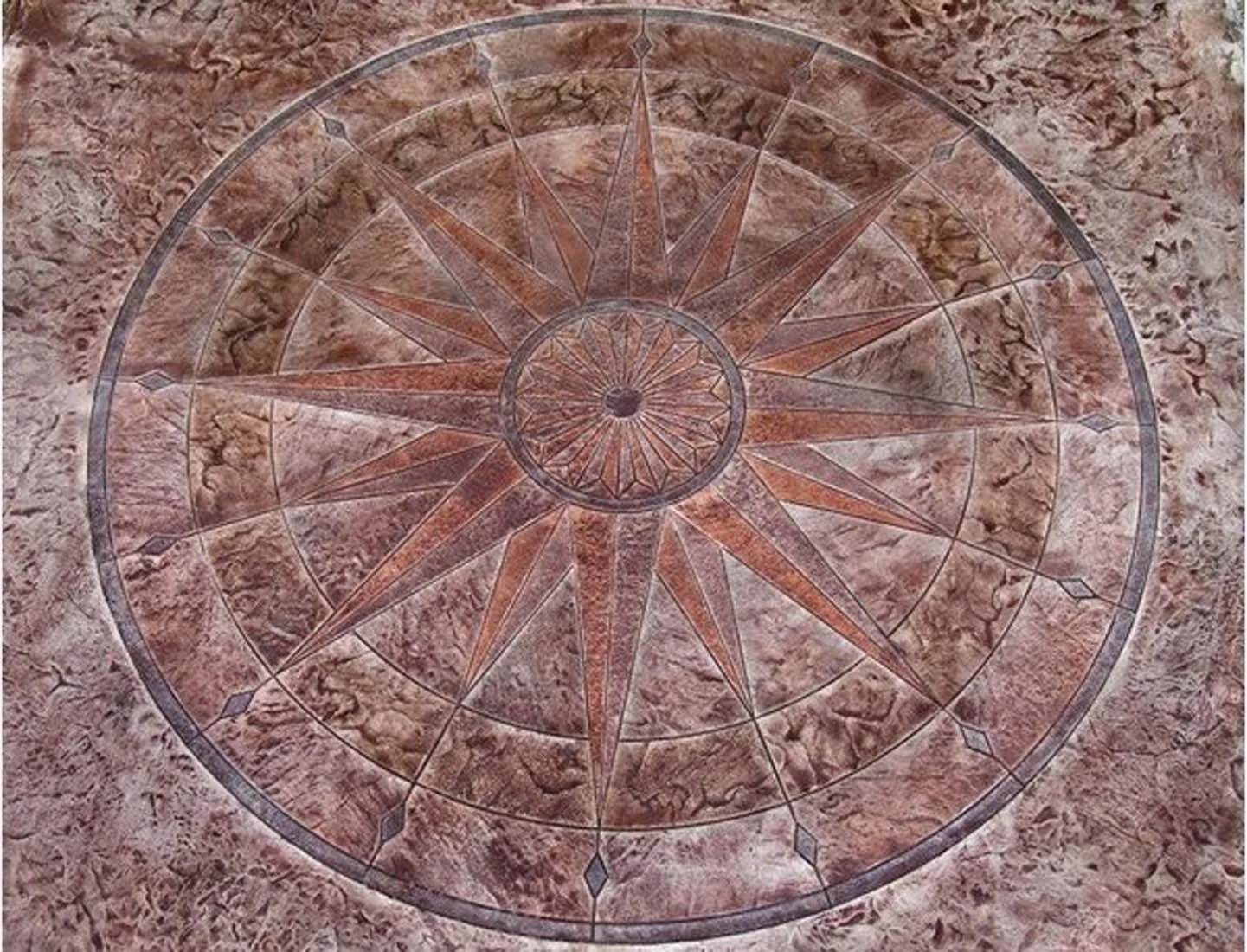 Sixteen-point compass medallion in decorative concrete by Interscope Contractors